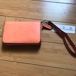 Brand new orange wristlet with tags